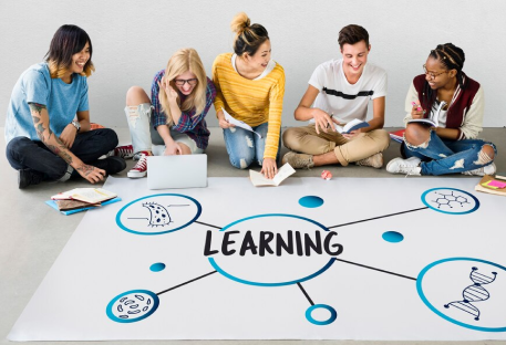 A person smiling while working on a laptop